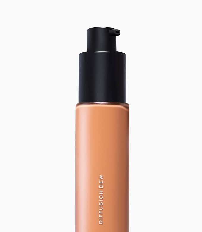 MAKE Beauty Diffusion Dew Skin Tint. Sheer to Medium Coverage Radiant Finish. Blurring, Smoothing, and Brightening for Glowing Complexion. Enhanced with Niacinamide and Adenosine. Suede 12