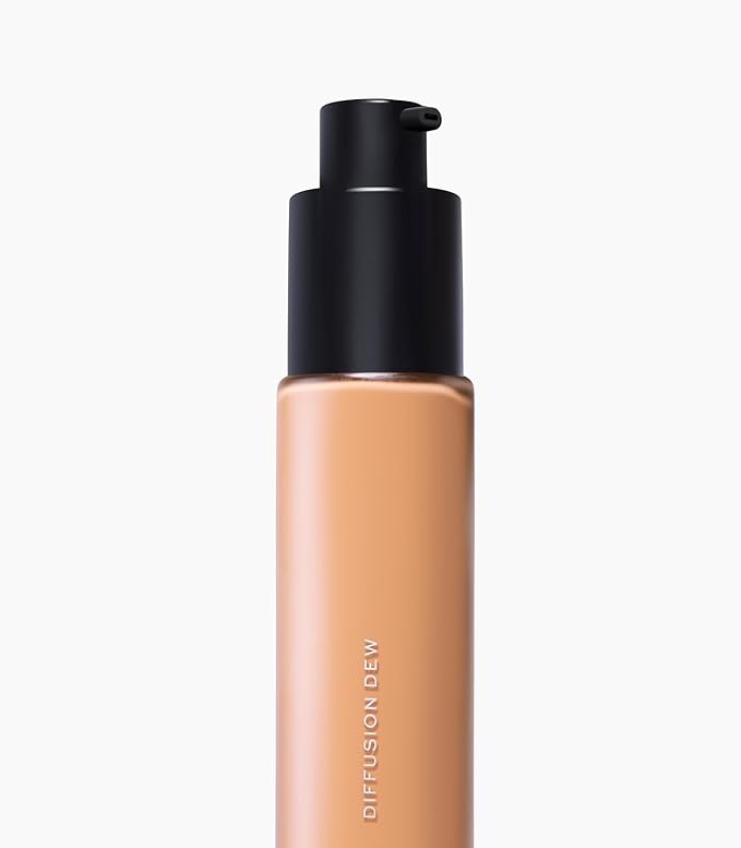 MAKE Beauty Diffusion Dew Skin Tint. Sheer to Medium Coverage Radiant Finish. Blurring, Smoothing, and Brightening for Glowing Complexion. Enhanced with Niacinamide and Adenosine. Amber 10